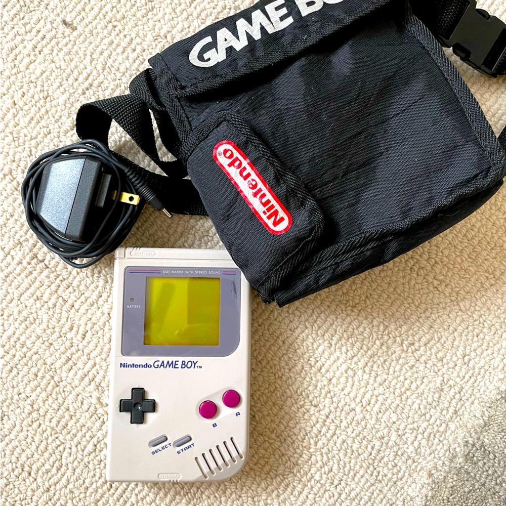Nintendo Game Boy with charger, bag and 9 different games.